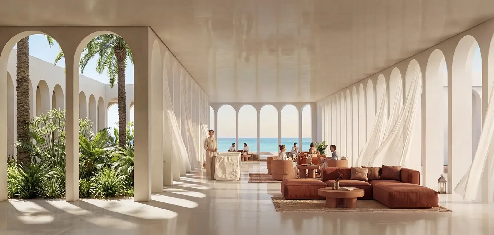 Luxury hotel lobby with arched colonnades, ocean views, refined lounge seating, and natural light connecting indoor and outdoor spaces.